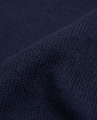 Close-up of navy blue fabric showcasing the soft knit texture of the Navy Blue Obi Cardigan.