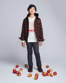 Boy wearing an Olive & Red Plaid Glen Hooded Shirt with apples scattered around.