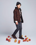 Boy wearing an Olive & Red Plaid Glen Hooded Shirt, surrounded by apples, showcasing casual fall style.