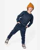 Child wearing the Blue Houndstooth Revel Crewneck and matching pants, showcasing a stylish houndstooth pattern.