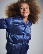 Happy child wearing a stylish Navy Blue Puffy Coat, perfect for winter outdoor adventures.