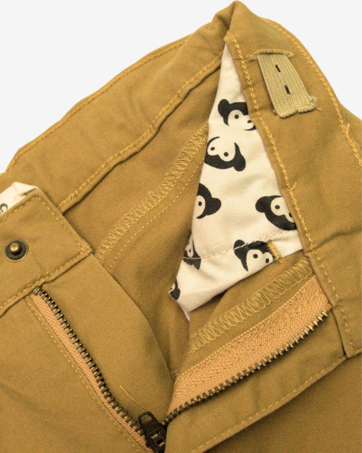 Inside view of British Khaki Skinny Twill Pants featuring playful panda lining and sturdy zipper details.
