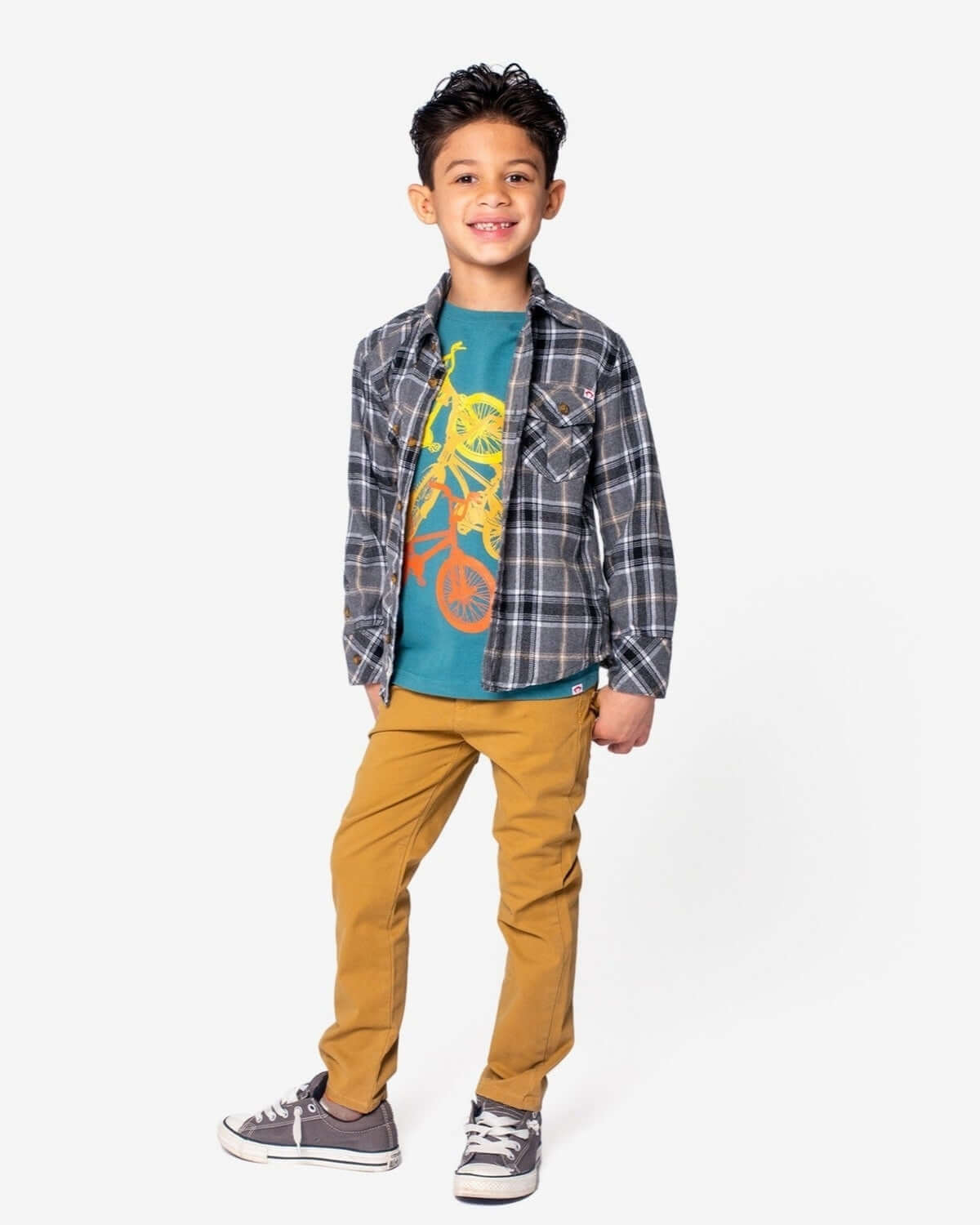 Boy wearing British Khaki Skinny Twill Pants with a plaid shirt and graphic tee, showcasing a stylish casual outfit.
