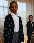 Electrifying Standard Button Down worn under a lightning bolt cardigan, showing stylish kids' fashion in natural light.