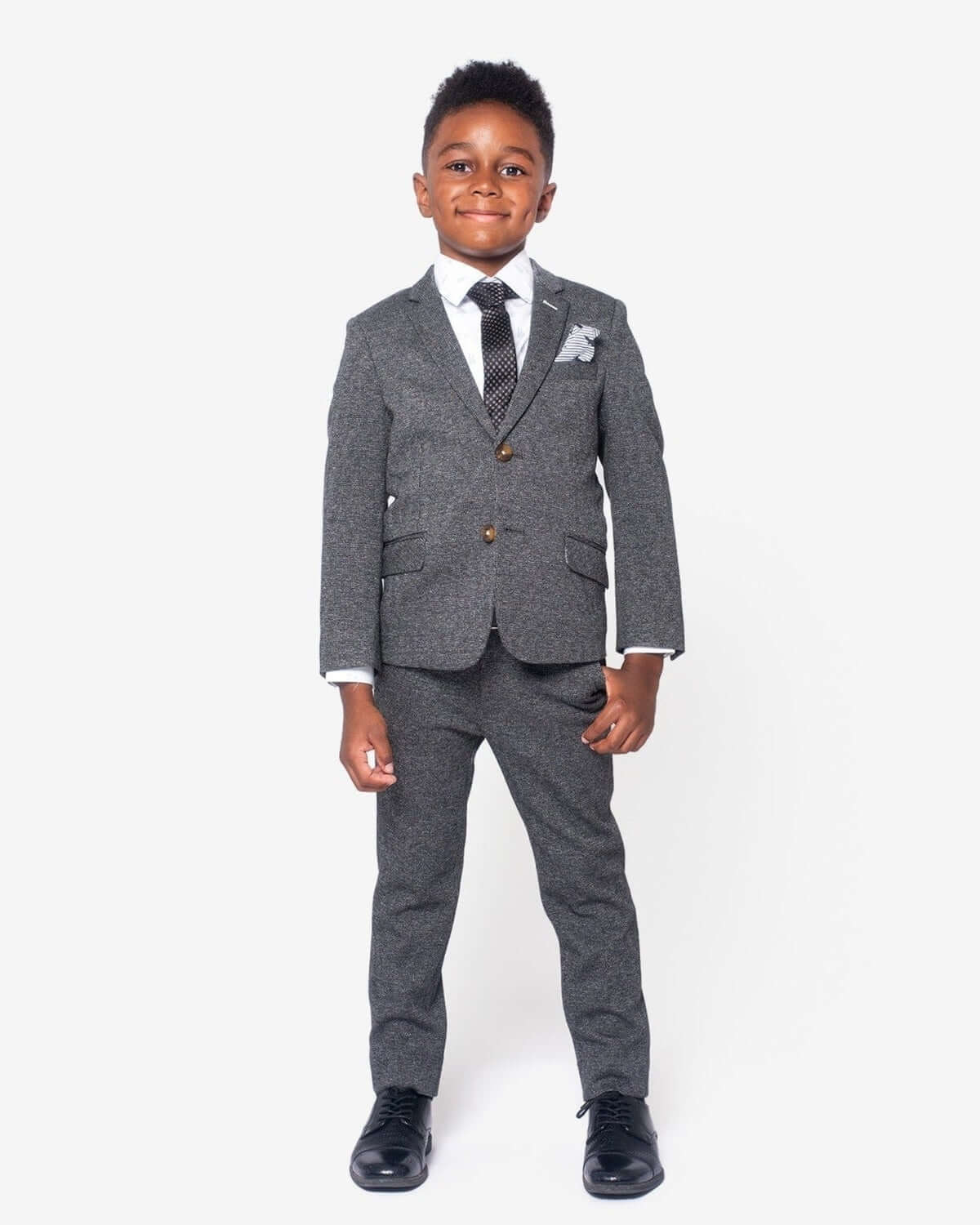 In The Wild Standard Button Down worn by a boy in a stylish gray suit, showcasing a tailored look for special occasions.