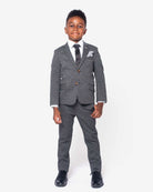 In The Wild Standard Button Down worn by a boy in a stylish gray suit, showcasing a tailored look for special occasions.