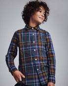 Lakeside Plaid Standard Button Down shirt on a smiling boy with curly hair, showcasing a colorful plaid pattern.
