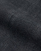 Close-up of Black Isle Tartan Stretchy Mod Suit fabric showcasing a textured dark plaid pattern.