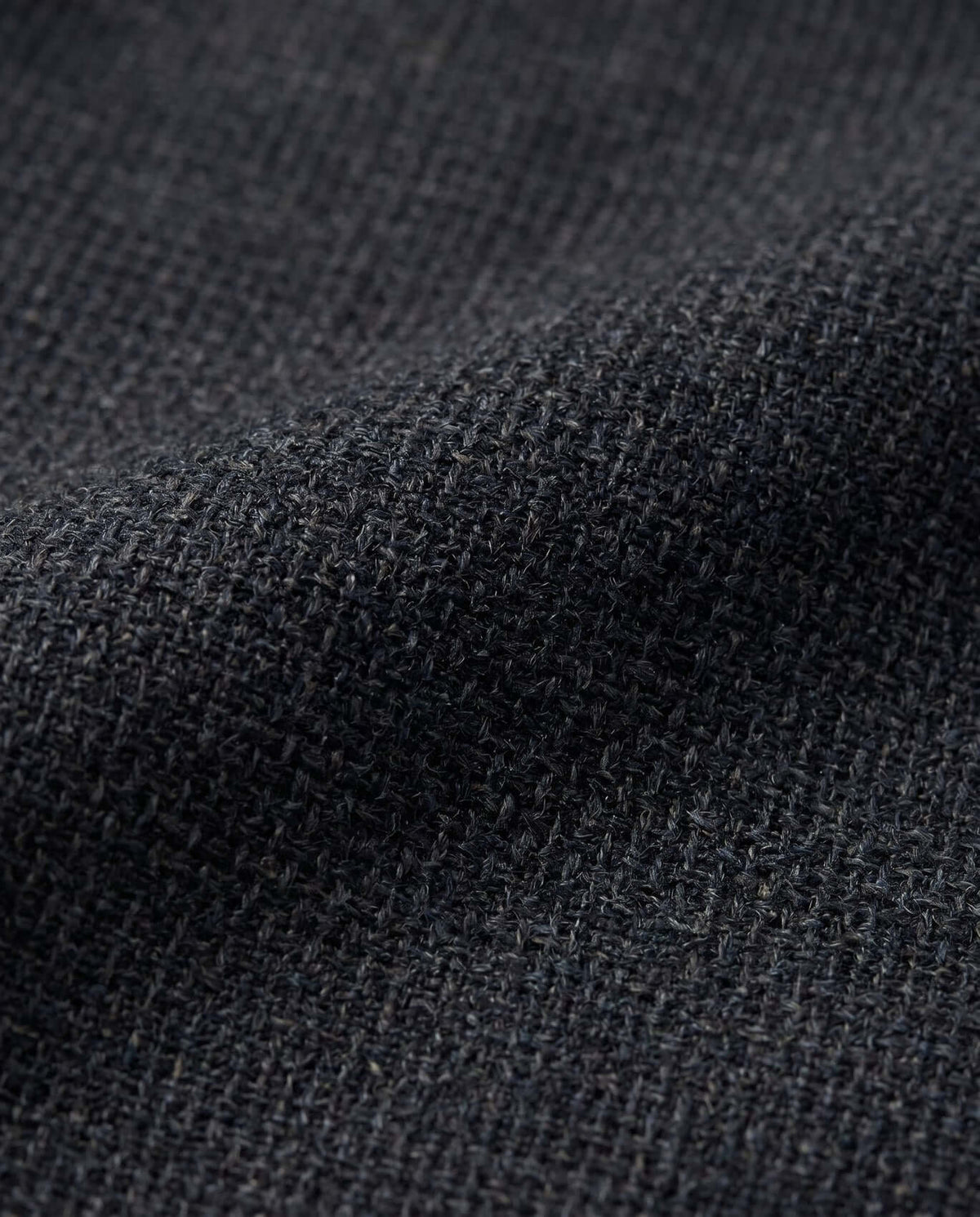 Close-up of Black Micro Houndstooth Stretchy Mod Suit fabric showcasing texture and detail.