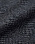 Close-up of the Black Isle Tartan Stretchy Mod Suit Pants fabric showing its texture and pattern.