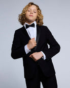 Black Tuxedo Suit Jacket worn by a young boy with a bow tie, perfect for formal events.