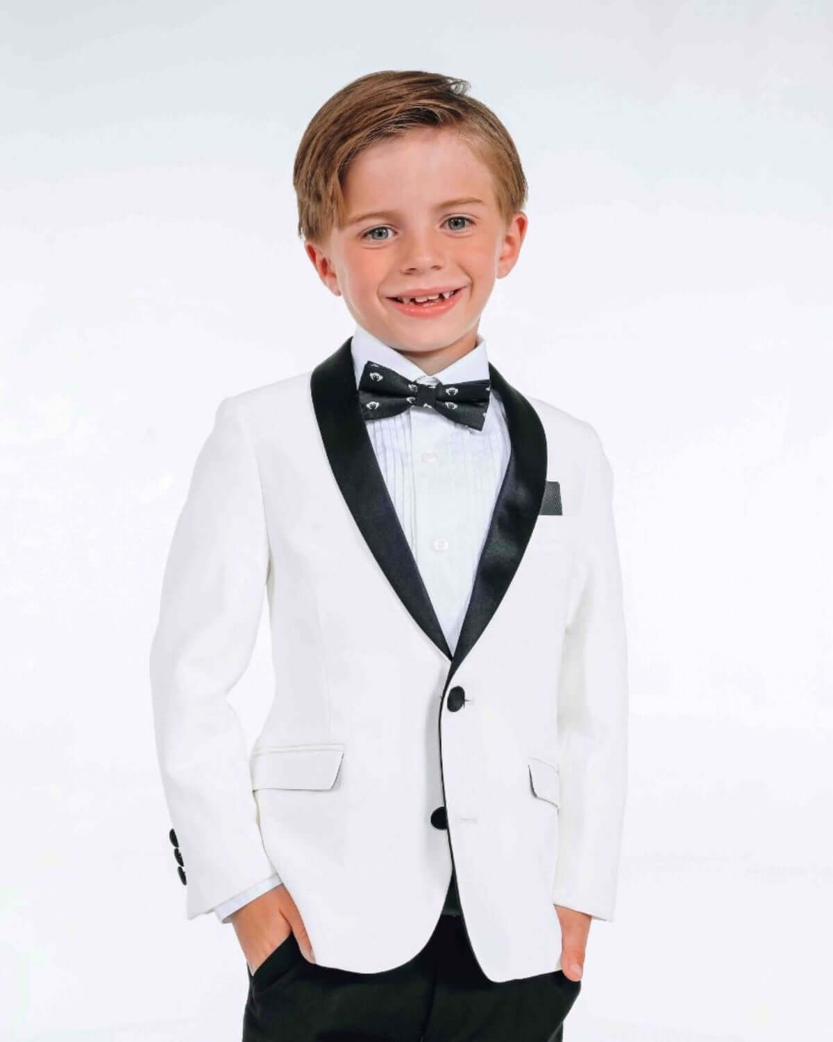 White Tuxedo Suit Jacket worn by a smiling boy, featuring satin lapels and a classic black-tie look.