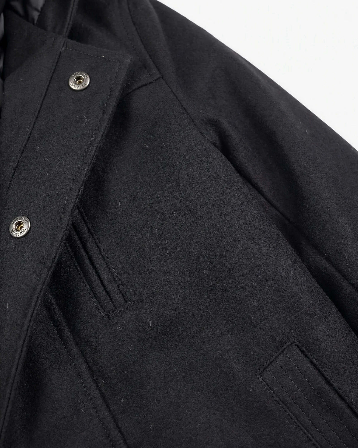 Black Urban Gotham Coat showing sleek black fabric and sharp tailoring details.