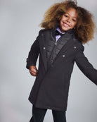 Smiling child wearing the stylish Black Urban Gotham Coat with removable vest.