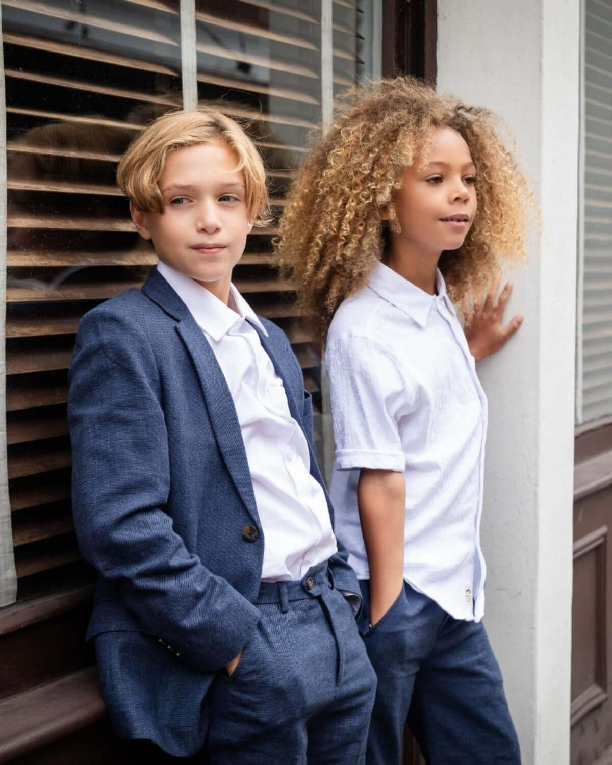 Two children in stylish outfits, showcasing the White Beach Shirt for summer adventures.