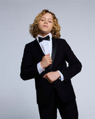 Young boy wearing a tuxedo with a bow tie and White Tuxedo Shirt, ideal for formal events.