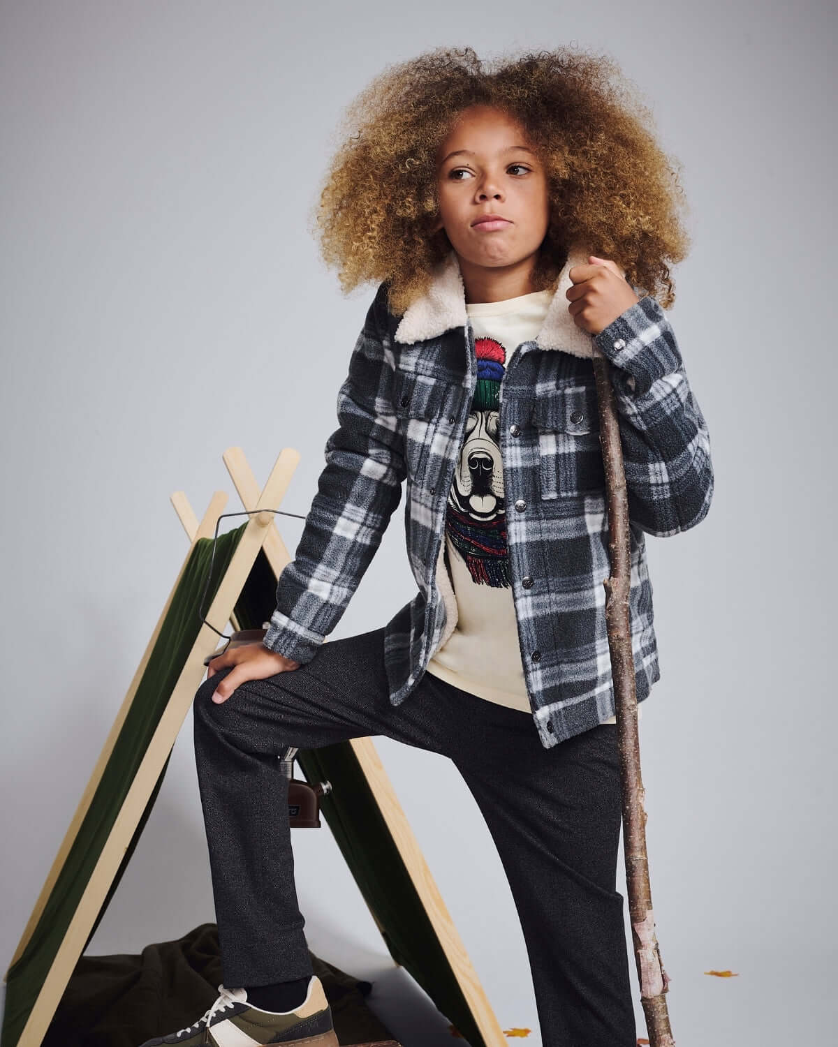 Child wearing a Winter Dog Graphic Long Sleeve Tee, layered under a checkered jacket, with a playful dog design.