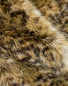 Close-up of the luxe leopard faux fur used in the Leopard Cleo Faux Fur Coat, showcasing its plush texture and warm colors.
