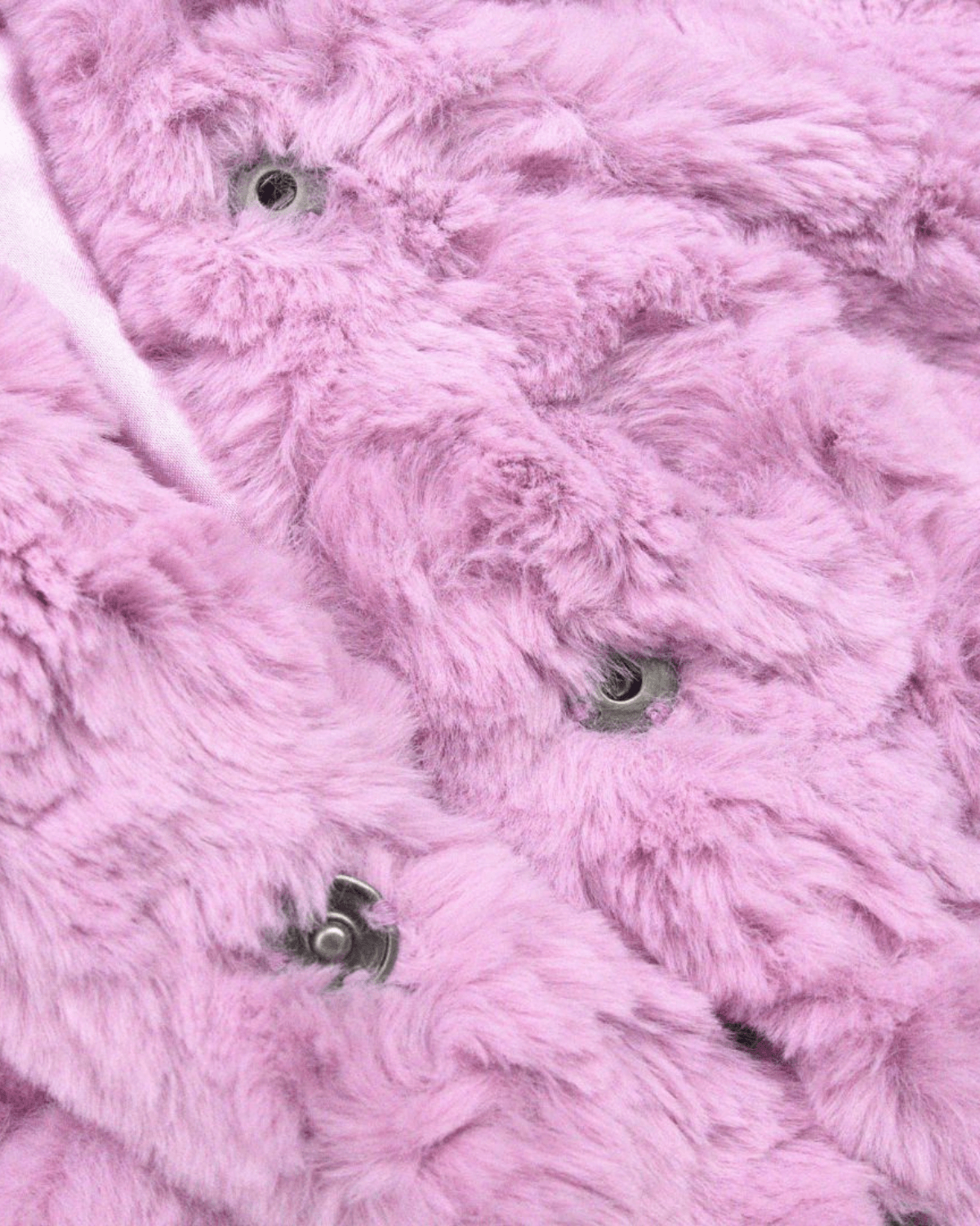 Close-up of the soft texture of the Pink Mousse Cleo Faux Fur Coat featuring pink fur and metal buttons.