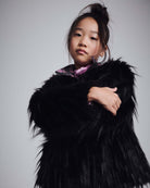 Black Faux Fur Coat worn by a young girl, showing cozy and stylish design with soft faux fur.