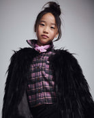 Black Faux Fur Coat worn by a young girl, showcasing a cozy and stylish look with a plaid top underneath.