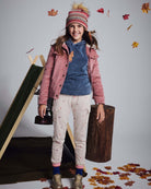 Girl wearing Heart Oatmeal Cozy Cargo Joggers with a pink jacket and beanie, surrounded by autumn leaves.