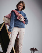 A model wearing Heart Oatmeal Cozy Cargo Joggers with a blue hoodie and jacket against a cozy background.