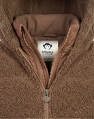 Close-up of a brown fleece zip-up jacket with a tan interior lining and a visible Appaman Outfitters neck label.
