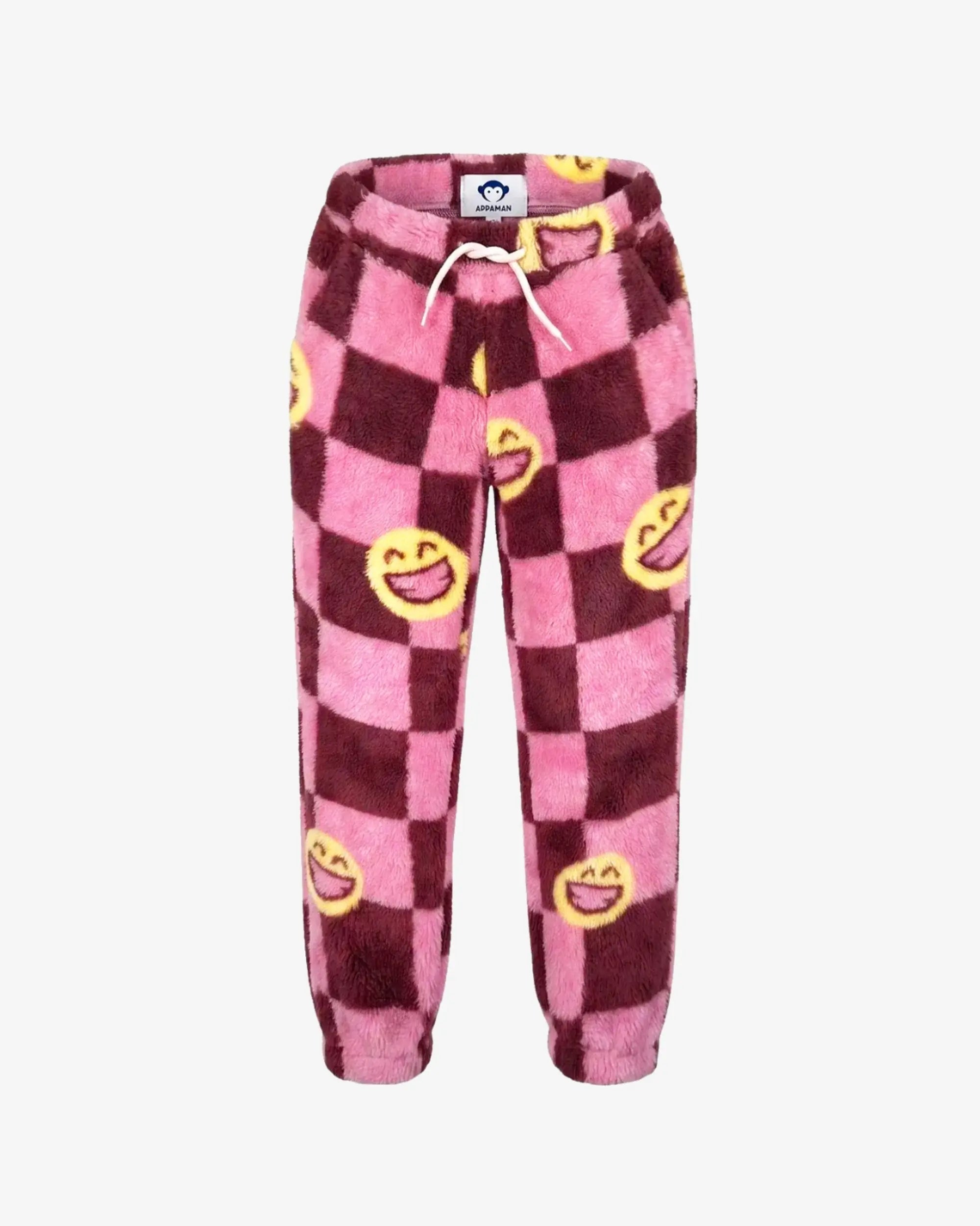 Pink and dark red checkered fleece pants with yellow smiley face prints and a white drawstring, shown against a plain white background.