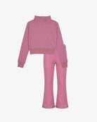 A two-piece children's lounge set in dusty pink ribbed fabric, featuring a long-sleeve half-zip mock-neck top and matching flared pants, displayed on a clean white background.