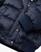 Appaman girls' navy puffer bomber jacket, close-up cuff snap detail.
