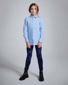 Girl wearing Navy Twilight Leggings with a light blue shirt and black boots.