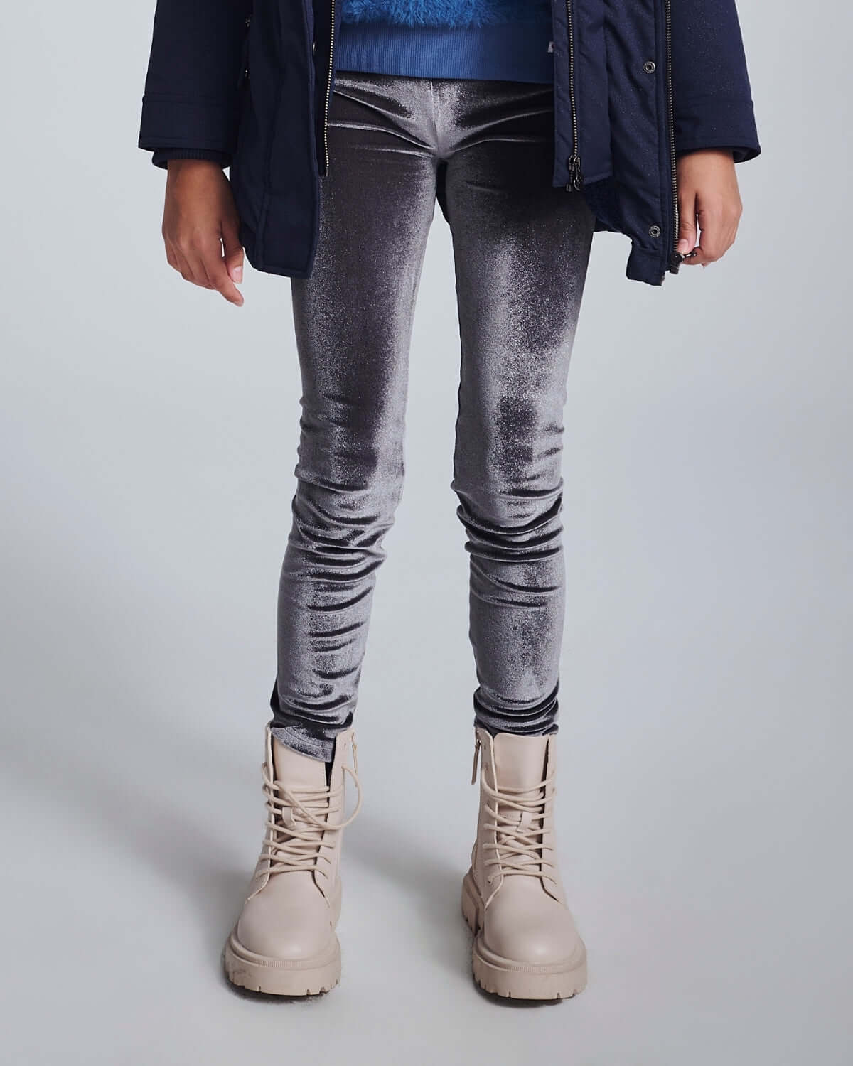 Child wearing Silver Frost Legging with beige boots, showcasing shiny, stretchy comfort in a stylish look.