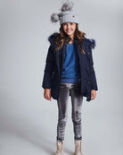 Girl wearing Silver Frost Legging with a blue sweater and winter coat, showcasing stylish comfort for kids.