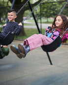 Kids enjoying a swing set wearing Dusty Rose Liana Jeans and colorful sweaters in a park setting.