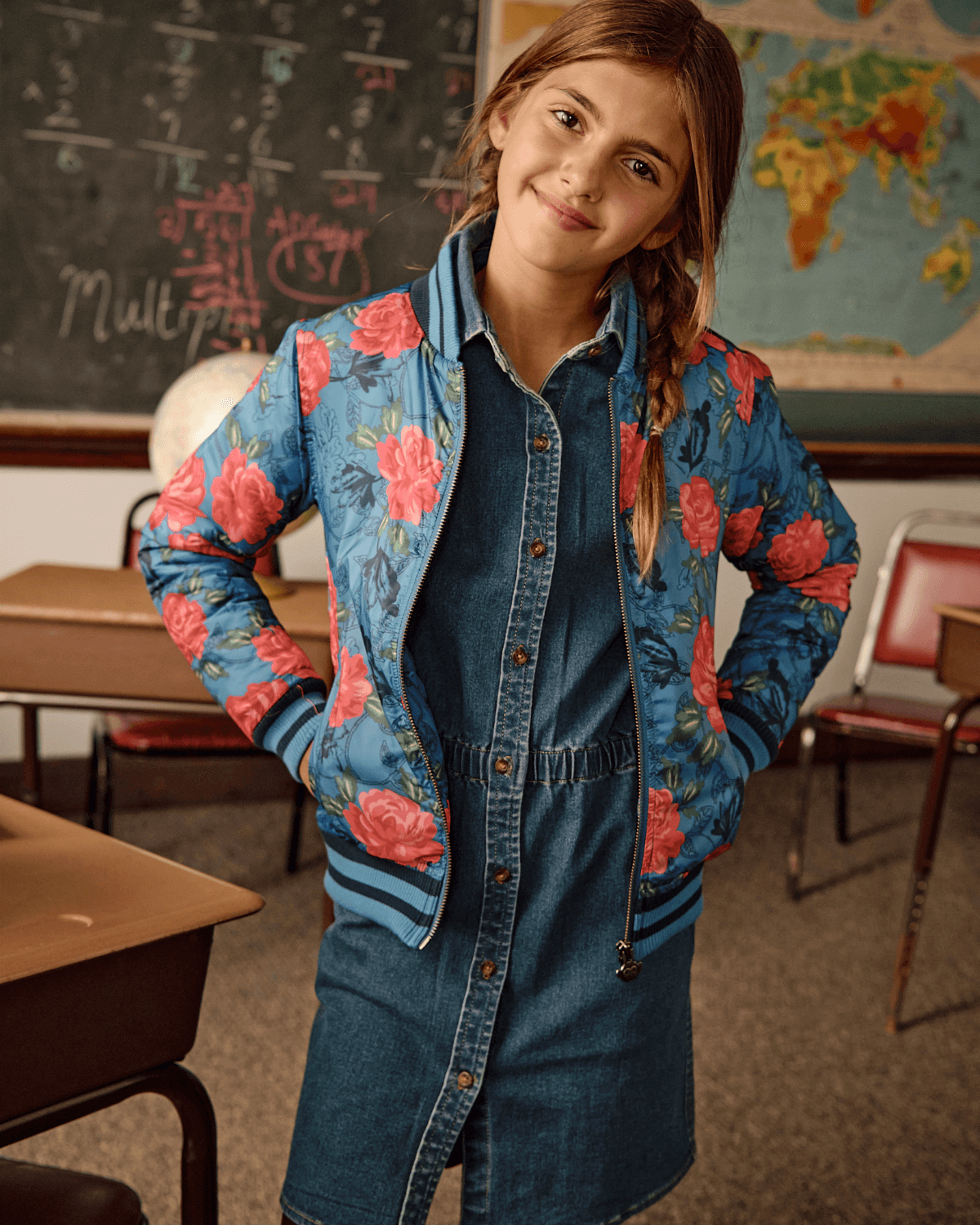 Bluebell Rose Garden Nikki Bomber Jacket on girl in classroom with denim dress and stylish flower pattern.