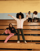Heart Oatmeal Cozy Raglan Hoodie worn by kids on bleachers, showcasing playful style and comfort.