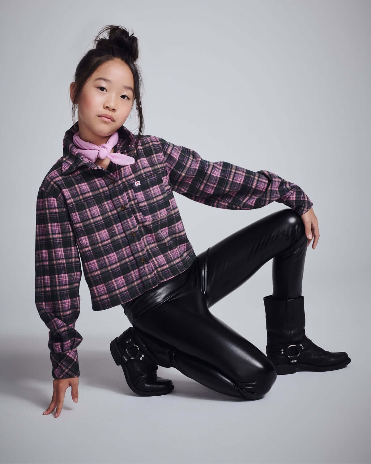 Girl wearing Pink Plaid Polly Cropped Flannel shirt with black leather pants and a pink scarf.