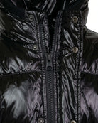 Black Glitter Puffy Coat close-up showing glossy texture and zipper detail.