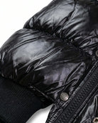Close-up of the Black Glitter Puffy Coat showcasing the shiny black fabric and quilted texture.