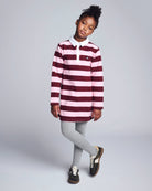 Pink Stripes Quinn Oversized Dress worn by a girl with gray leggings, featuring pink and burgundy stripes, ideal for comfort.