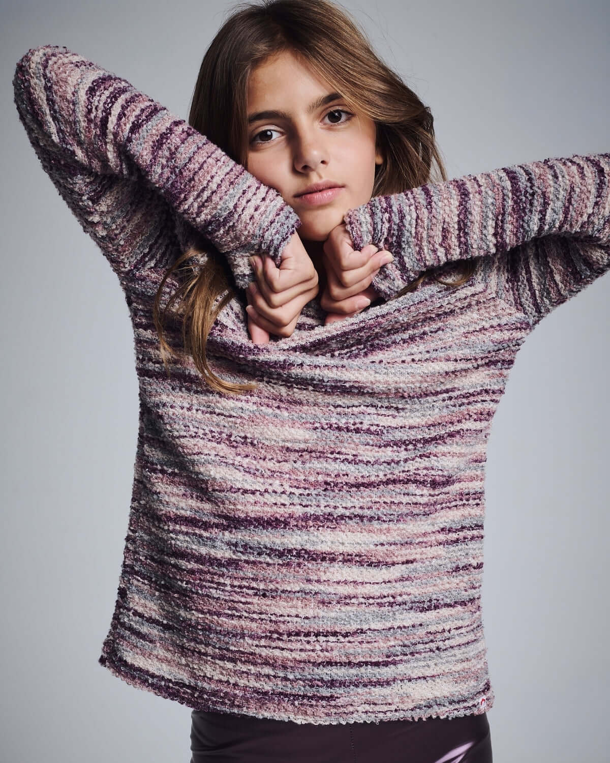 Purple Mix Boucle Ruslana Top on a young girl, showcasing cozy boucle fabric in bold purple hues.