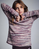 Purple Mix Boucle Ruslana Top on a young girl, showcasing cozy boucle fabric in bold purple hues.