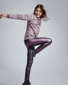 Girl wearing the Purple Mix Boucle Ruslana Top with shiny leggings, showcasing a playful and stylish outfit.