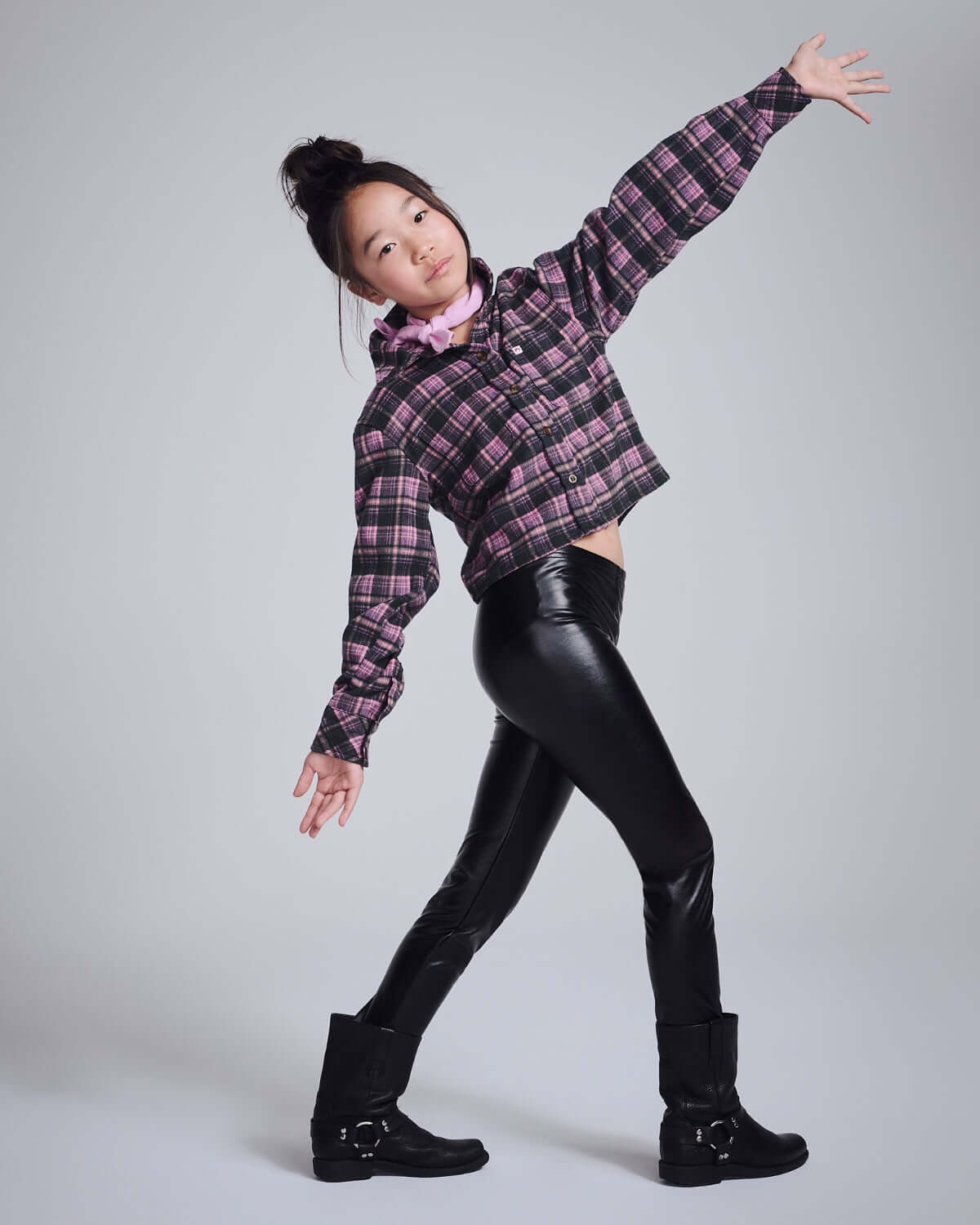 Active child in stylish Black Shine Leggings and a plaid crop jacket, showcasing comfort and style.