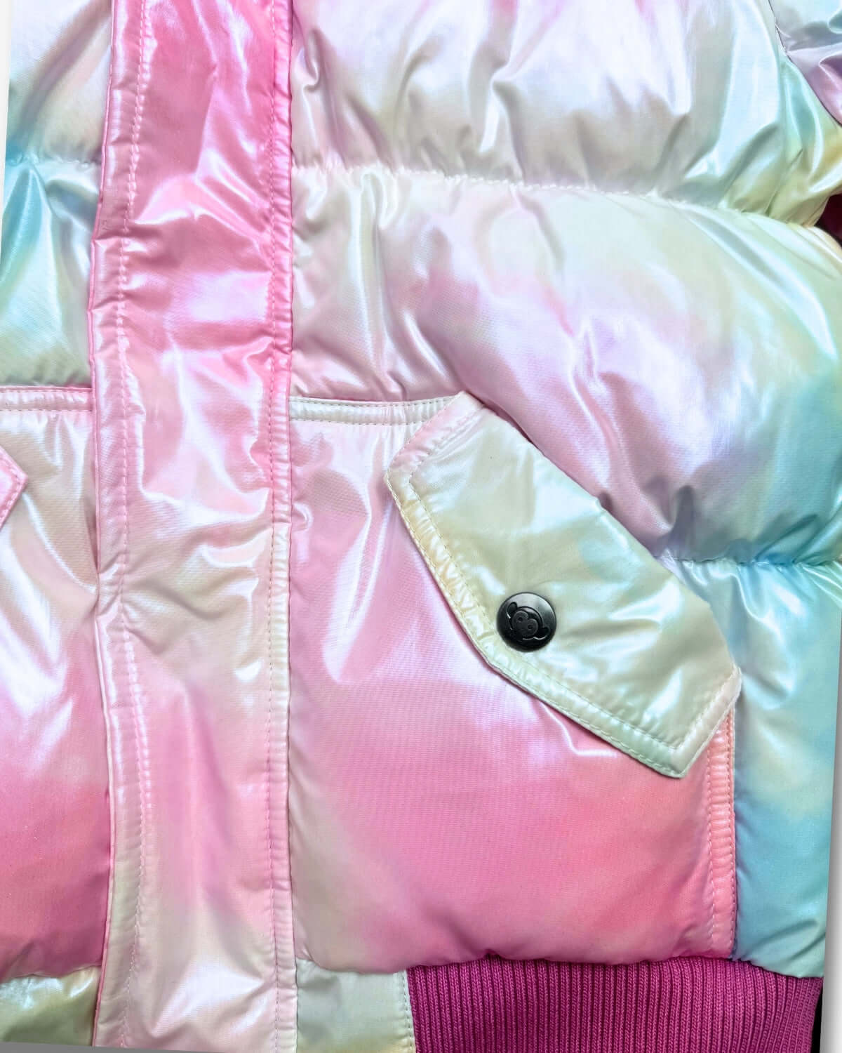 Close-up of the Iridescent Pink Slim Puffy Coat showing the shiny fabric and pockets.