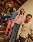 Four kids showcasing cozy outfits, including the Rose Quartz Stanton Joggers, on a staircase.