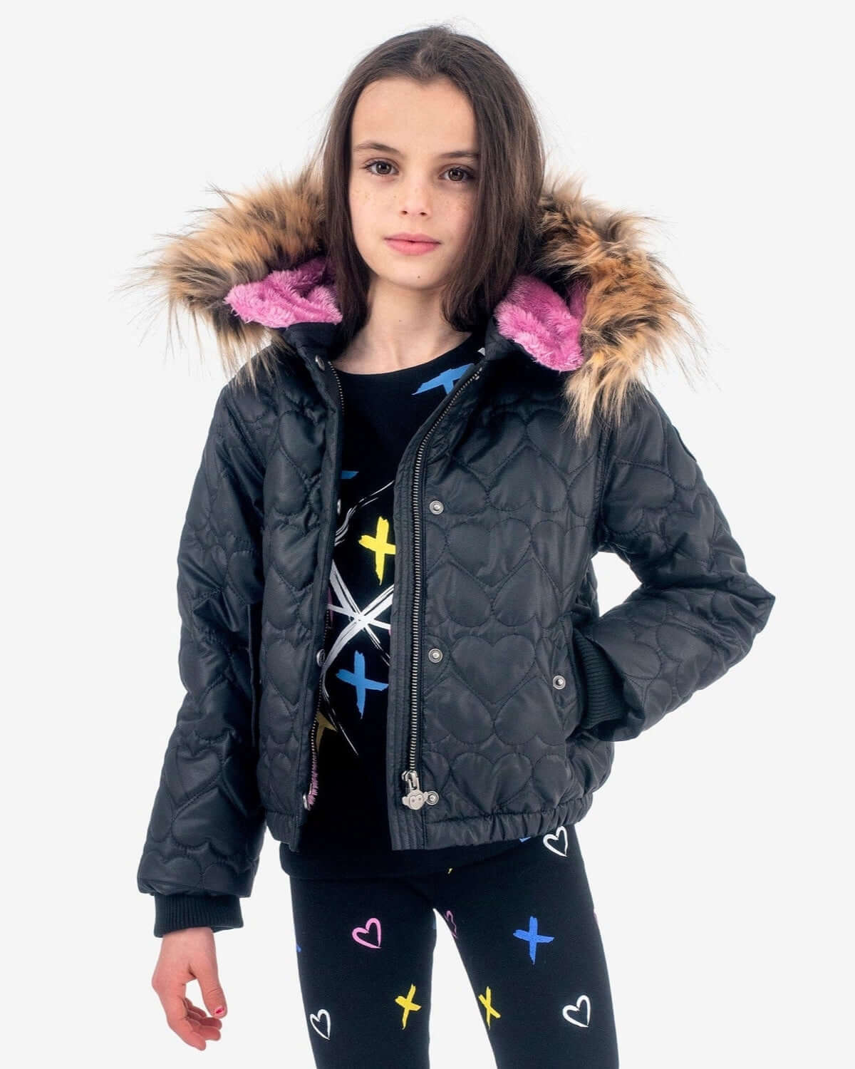 Black Wilderness Jacket worn by a girl, featuring heart quilting and a detachable fur-trimmed hood.