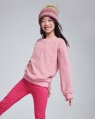Girl wearing the Ivy Rose Willow Top, a cozy fuzzy pink top paired with pink leggings, perfect for chilly days.