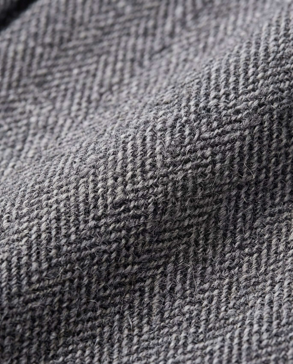 Close-up of luxurious fabric texture in gray herringbone pattern for Black Boucle Yoke Pleated Skirt.